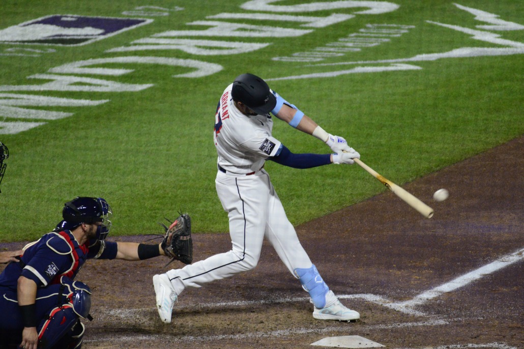Kris Bryant hits a ball to left field.