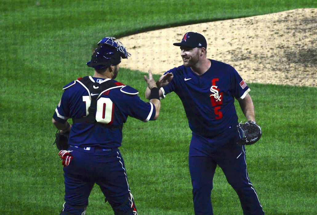 White Sox pitcher Liam Hendricks and Rays catcher Mike Zunino celebrate closing out the game. 