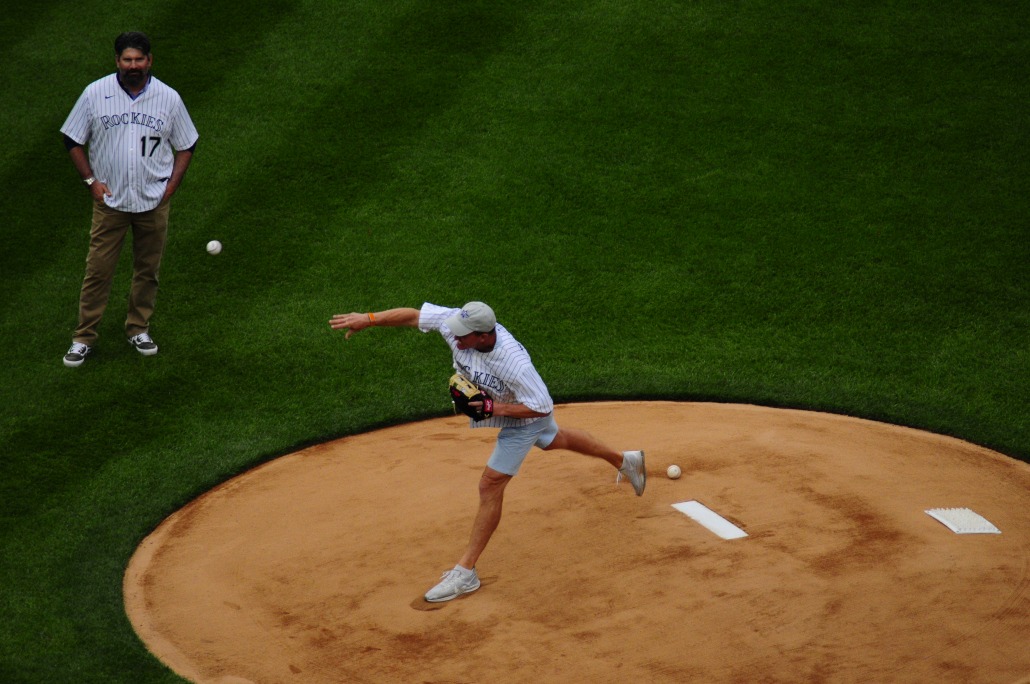 NFL legend Peyton Manning throws the first pitch in front of Todd Helton. 
