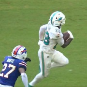 De'Von Achane runs for one of his two touchdowns in the Dolphins' win against the Bills.
