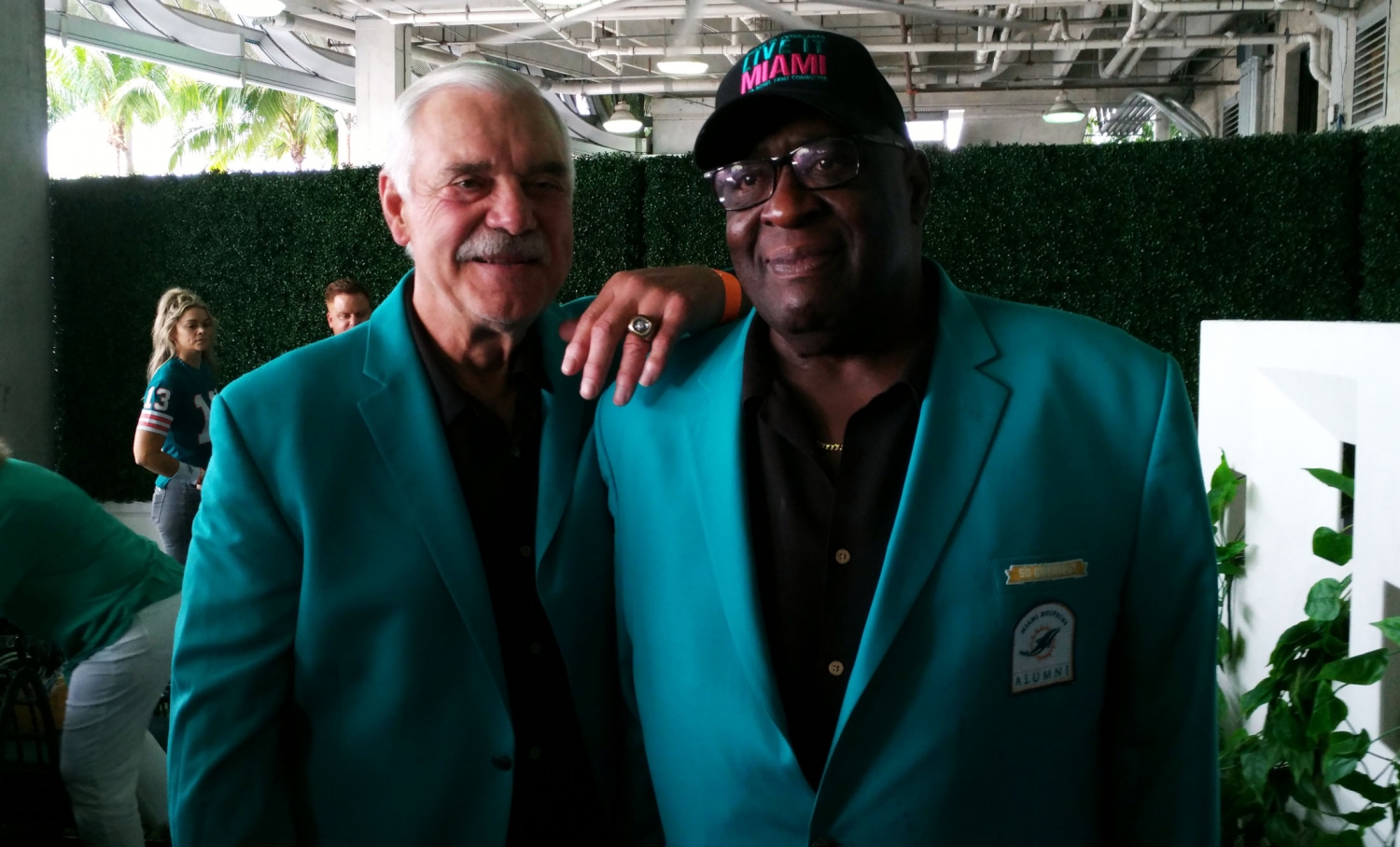 Larry Csonka, left, and Larry Little join in celebration of the 1972 Dolphins being chosen as the NFL's greatest team. (Craig Davis/Five Reasons Sports)