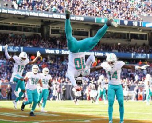 Tyreek Hill does a flip in celebration of scoring a touchdown for the Dolphins in the win against the Bears.