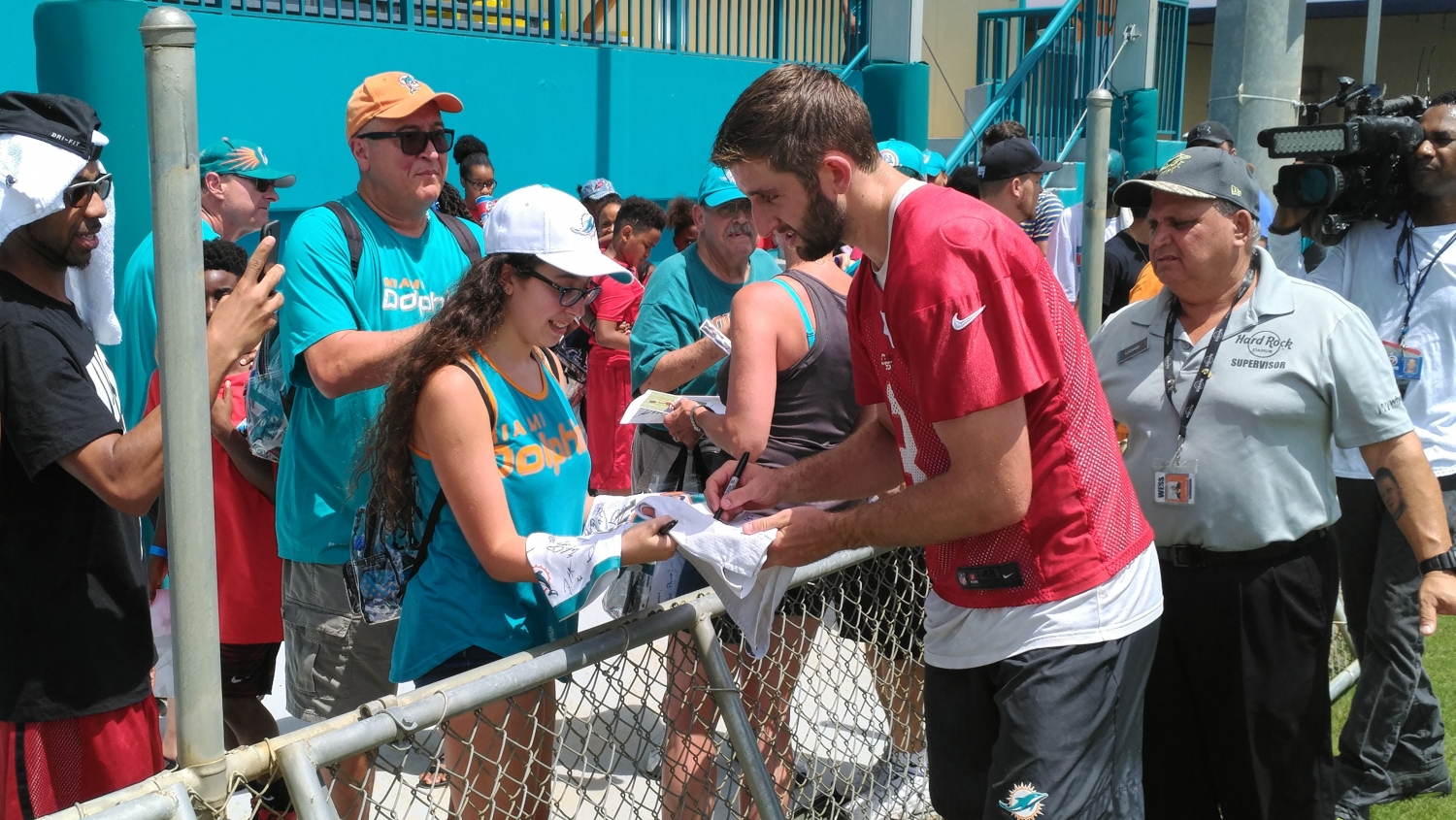 Josh Rosen signs autographs for fans following the first workout of Dolphins training camp on Thursday. (Craig Davis)