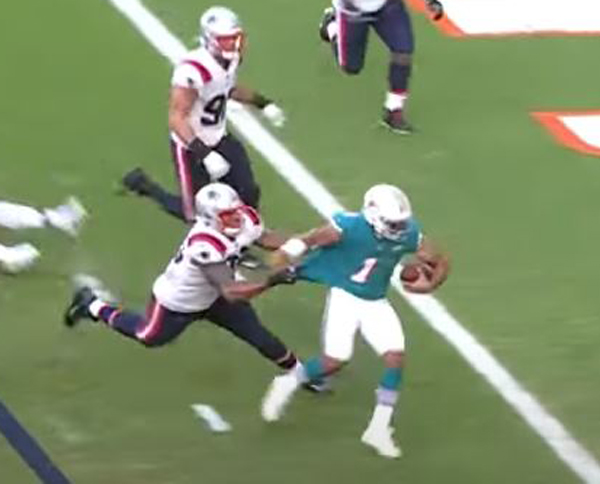 Tua Tagovailoa scrambles for the first of two touchdowns in a 22-12 Dolphins win over the Patriots.