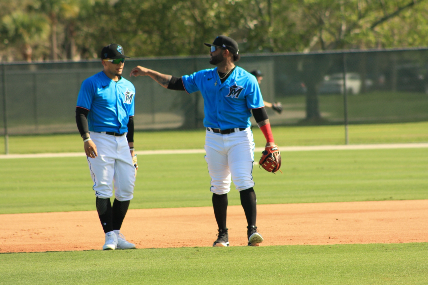 Jonathan Villar, right, works with Isan Diaz on the first day of spring training. Villar, an infielder, could end up in center field. (Craig Davis for Five Reasons Sports)
