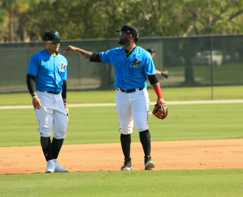 Jonathan Villar, right, works with Isan Diaz on the first day of spring training. Villar, an infielder, could end up in center field. (Craig Davis for Five Reasons Sports)