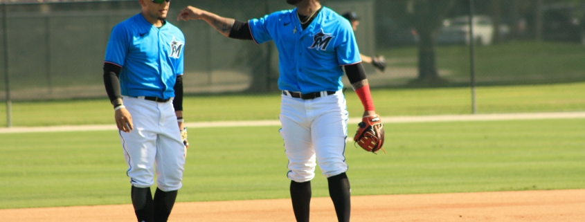 Jonathan Villar, right, works with Isan Diaz on the first day of spring training. Villar, an infielder, could end up in center field. (Craig Davis for Five Reasons Sports)
