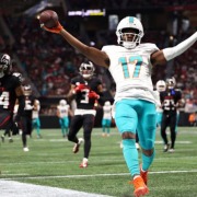 Jaylen Waddle catches one of four touchdown passes thrown by Tua Tagovailoa in the Dolphins' rout of the Falcons.