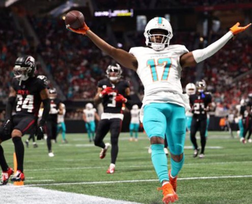 Jaylen Waddle catches one of four touchdown passes thrown by Tua Tagovailoa in the Dolphins' rout of the Falcons.