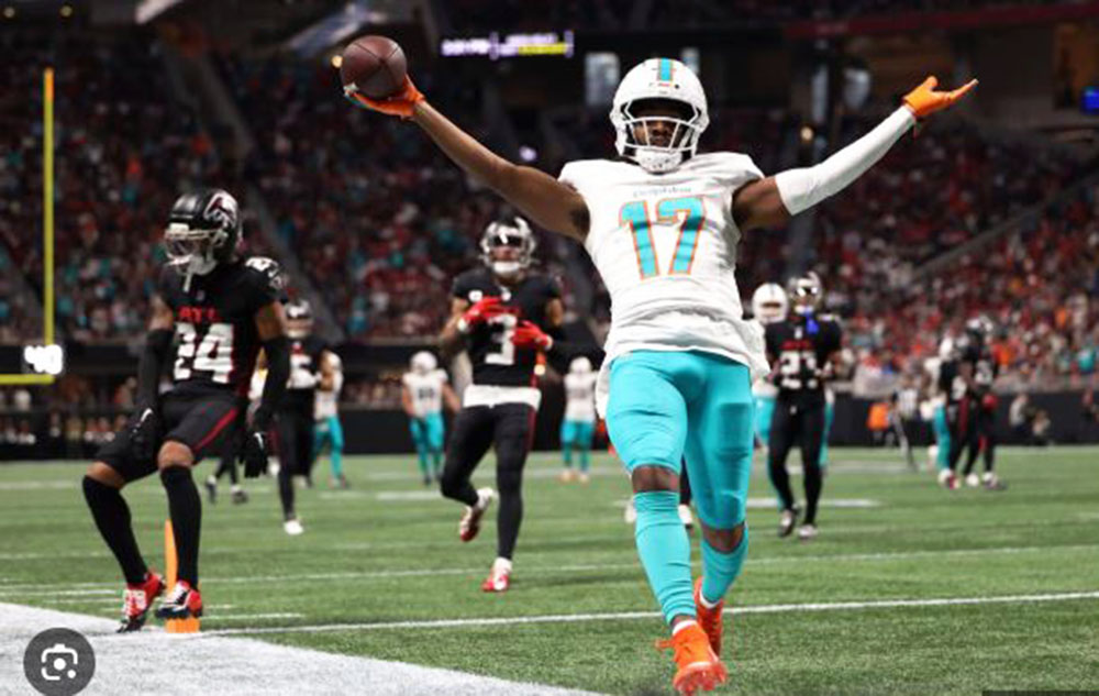 Jaylen Waddle catches one of four touchdown passes thrown by Tua Tagovailoa in the Dolphins' rout of the Falcons.